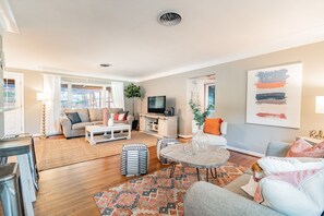 This spacious area boasts an open layout that seamlessly blends comfort with modern elegance.
