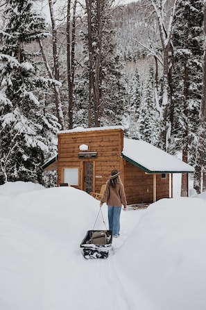During winter, a sled is provided to pull your luggage on a shoveled path to your riverside cabin.