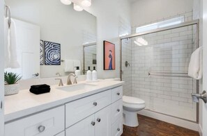 Bathroom with large subway tiled walk-in shower.