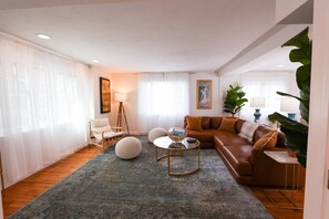Living room, lots of windows allowing for natural light to energize you.