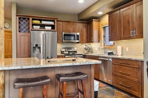 A fully-equipped kitchen with spacious granite countertops and a kitchen bar will have everything you need to whip up a delicious meal for your group.