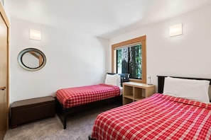 Two bedrooms are located on the lower level of the home including this bedroom with two twin beds.