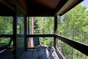 Sit back and listen to the sounds of nature from the private balcony surrounded by trees.