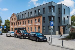 An exterior view of the building, showcasing its modern yet historic architecture in a peaceful neighborhood.
