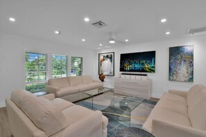 Open plan lounge with TV, Sofas and modern design