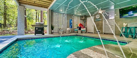 Private heated in-ground saltwater pool with a fountain