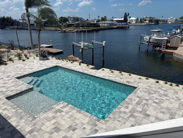 Beautiful pool with large paver deck, pretty landscaping & fantastic view.