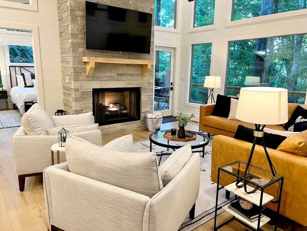 This spacious living room boasts a gas fireplace for the cooler nights and large windows for the beautiful bright days!