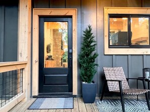 Just a few steps up from the driveway brings you to a comfortable landing.  It’s a cozy spot to sit and have intimate coffee conversations or nighttime star gazing.  