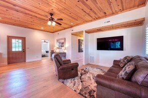 Living area with television includes a couch with a sofa bed for more sleeping space