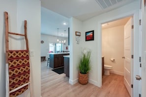 View of half bath and entry to fully stocked kitchen