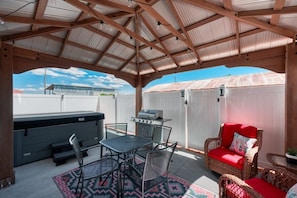 The back patio is a perfect spot to relax, eat, visit, or soak in the hot tub