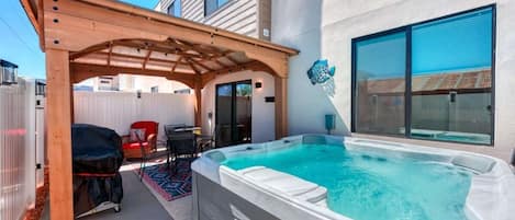 Spend your evenings out under the shady canopy on the back patio and take a soak in the hot tub