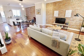 Enter into the living room filled with light from the font of the house to the back