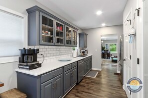 Fully stocked kitchen with coffee maker, dishwasher and more