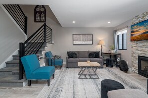 Living Room, Q sofa bed and stairway to 2nd floor + heated tile floors