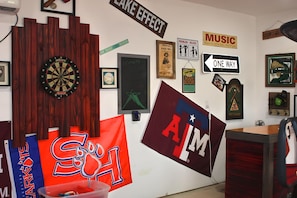 Bar area and dartboard in garage.