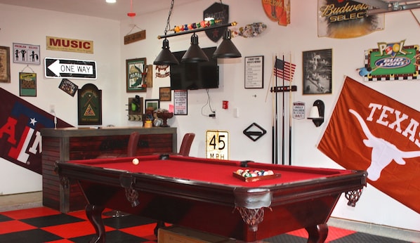 Pool table and bar area in garage.