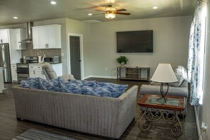 Living Room with Door to Laundry Room and Game Room