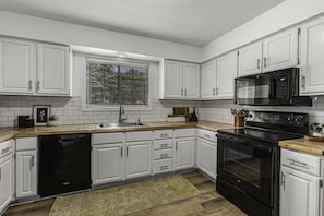 This large kitchen has tons of storage and full size appliances!