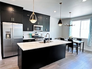 Fully stocked kitchen with gas stove (bar stools included; not pictured)