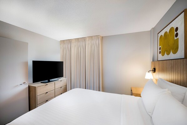 Newly renovated suite, features a private bedroom with a plush Queen bed.