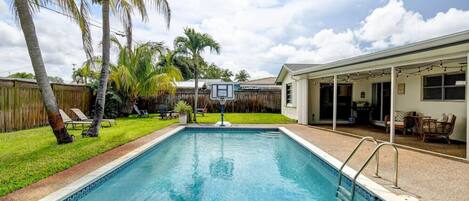 Who's up for a game of pool basketball? This backyard has it all: a refreshing pool to cool off in and a basketball hoop to stay active.