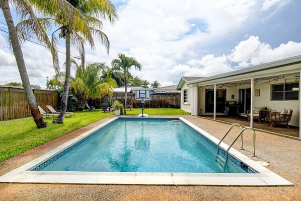 Who's up for a game of pool basketball? This backyard has it all: a refreshing pool to cool off in and a basketball hoop to stay active.