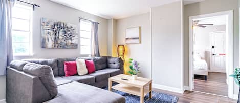 Modern and Inviting: Our living room offers modern furnishings in a clean, spacious setting. Enjoy the comfortable seating and welcoming environment. Perfect for relaxation and socializing Airbnb near Ohio State University Columbus!