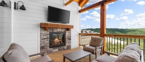 Outdoor fireplace on the top deck with great views