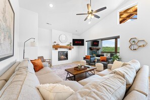 Cozy seating in the Living Room with electric fireplace, indoor & outdoor TVs