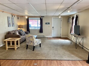 The living room is large and has a modern flat-screen TV for your enjoyment.