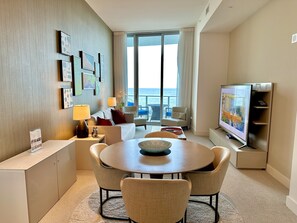 Living room with OCEAN VIEW that comes with a sofa bed and 86” smart TV. 