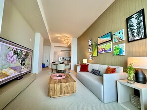 Living room with OCEAN VIEW that comes with a sofa bed and 86” smart TV. 