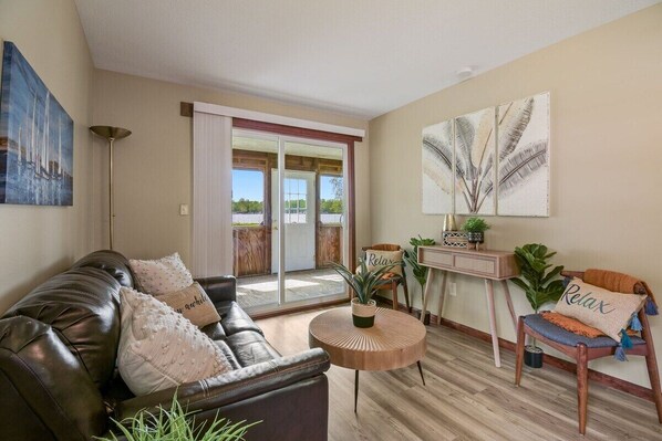 Modern living area with patio doors overlooking the water