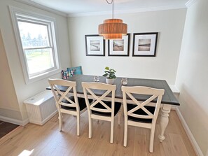 Banquette seating provides space for up to 8 people at dining table. 