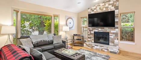 Enjoy movie nights in the cozy living room with gas fireplace and smart TV.