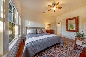 Bedroom with king-size bed and lots of natural light from large windows