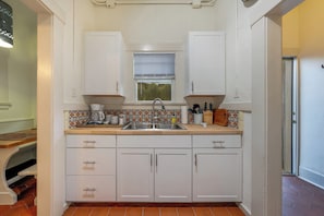 Kitchen sink with counters and cabinets stocked for your stay