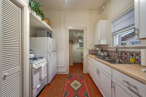 Kitchen with full-size fridge and freezer, stove, oven, and microwave