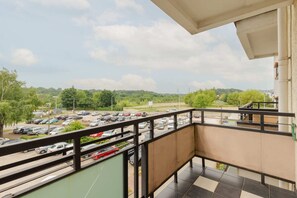 A private balcony with seating and a view of the garden and surrounding area.
