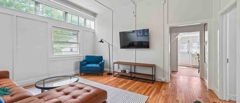 Living Room located up the entry stairs to the right just outside of the two bedrooms - vaulted ceilings, historic transom windows for loads of natural light, Office Space