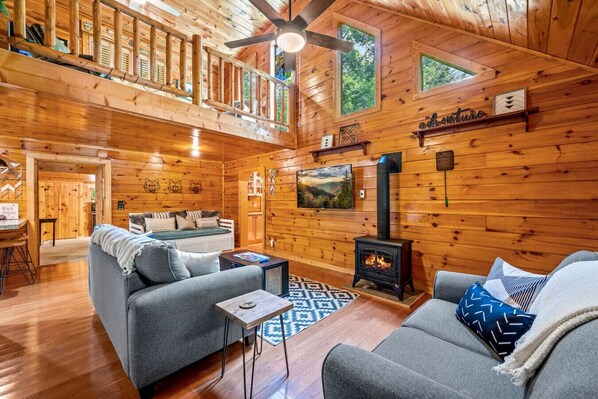 Gorgeous living room area with high ceilings, natural light, comfortable furniture and plenty of space to spread out and relax.