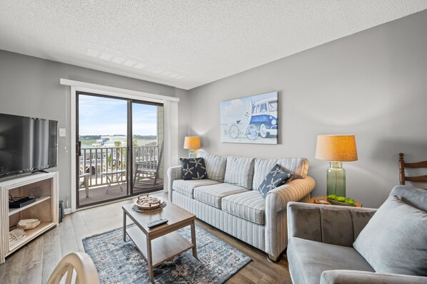 Relax in the comfort of a large well-appointed living room with a marsh view.
