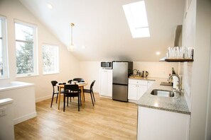 Kitchen and open dining room with granite countertops.