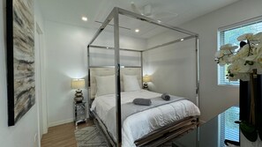 The master 4-poster King bed, fitted with premium cotton linens & down duvet.