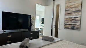 The master bedroom also boasts a 55” TV and walk-in closet.