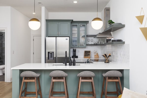 Seating for 4 at the kitchen counter, perfect for cooking & convening over a meal.