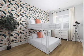 Comfortable full-over-full bunk beds in bedroom #2 with a fun wallpaper print. Plenty of dresser & closet space for storing your clothes.