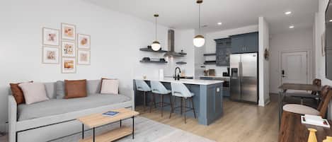 Open floor plan with lots of natural light, Smart TV, and seating at the kitchen counter. There is also a separate high-top dining table with seating for 4.